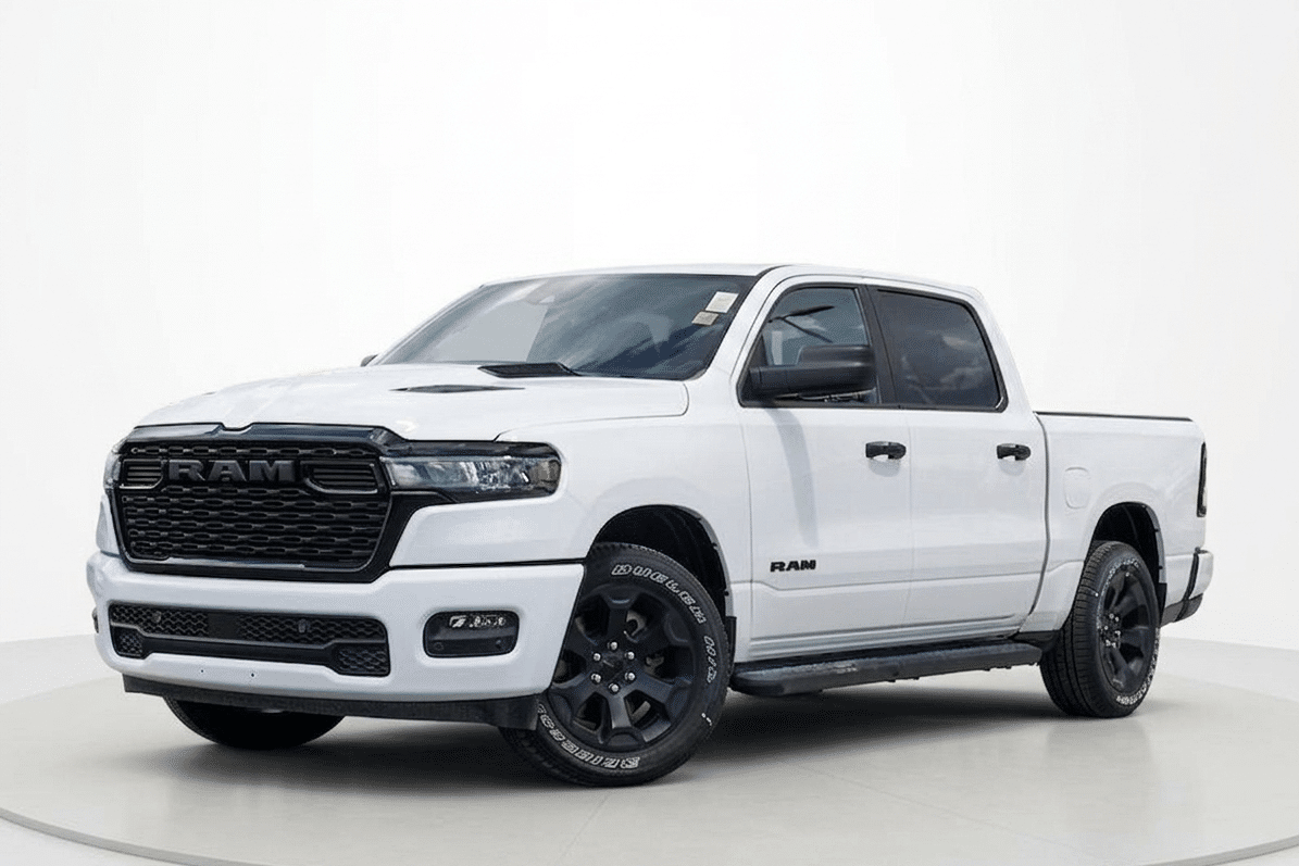 White RAM truck with black grille and tinted windows on a white background.